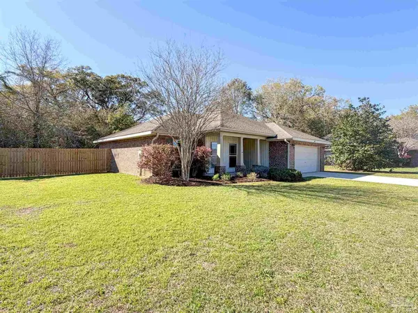 a front view of house with yard and ocean view