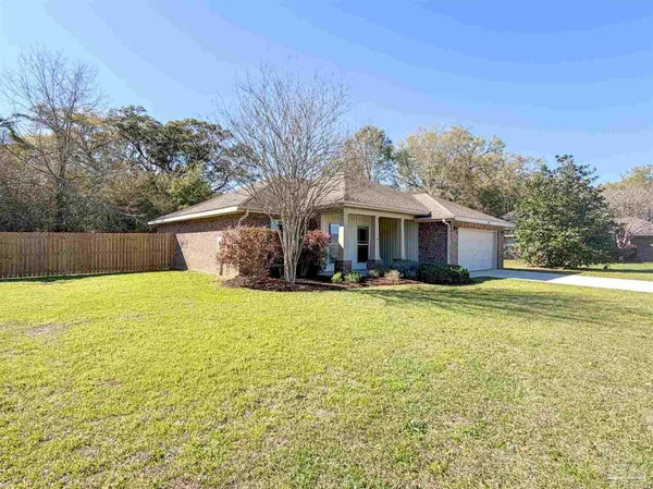a front view of house with yard and ocean view