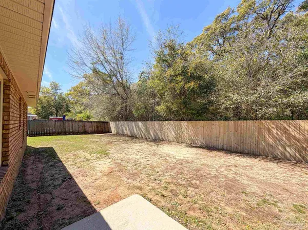 a view of backyard with swimming pool