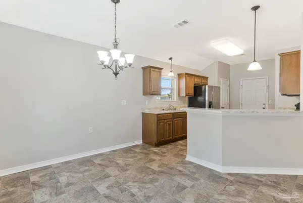 a view of a kitchen with a sink and dishwasher a refrigerator with wooden floor