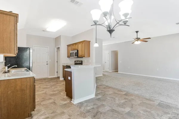 a view of a kitchen with a sink and a chandelier