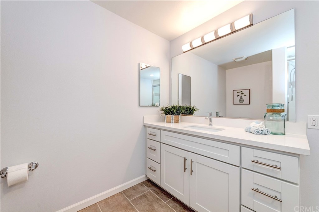 100 South Alameda Street, Unit 210 Los Angeles, CA 90012 - Photo 13 of 52 a spacious bathroom with a double vanity sink and mirror