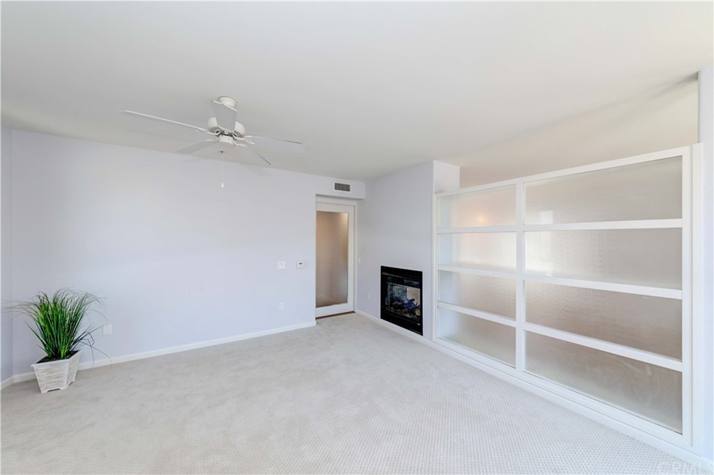 100 South Alameda Street, Unit 210 Los Angeles, CA 90012 - Photo 16 of 52 a view of an empty room with a fireplace and a window