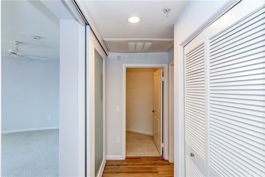 100 South Alameda Street, Unit 210 Los Angeles, CA 90012 - Photo 24 of 52 a view of a hallway with wooden floor and staircase