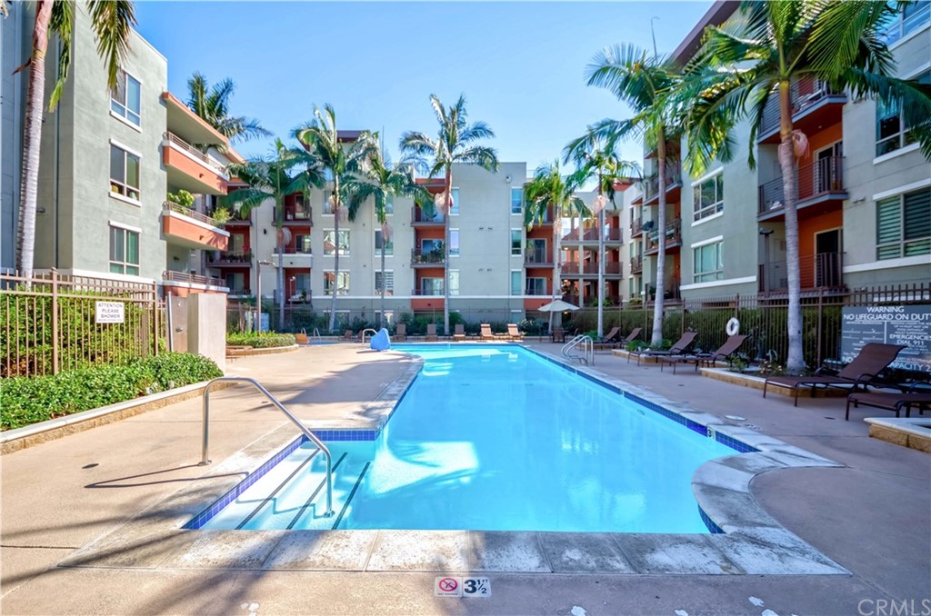 100 South Alameda Street, Unit 210 Los Angeles, CA 90012 - Photo 30 of 52 a swimming pool with outdoor seating and yard