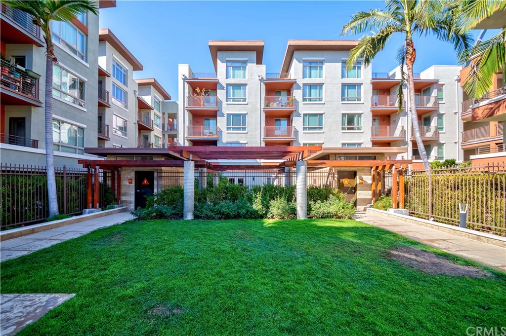 100 South Alameda Street, Unit 210 Los Angeles, CA 90012 - Photo 32 of 52 front view of an apartment building with a yard