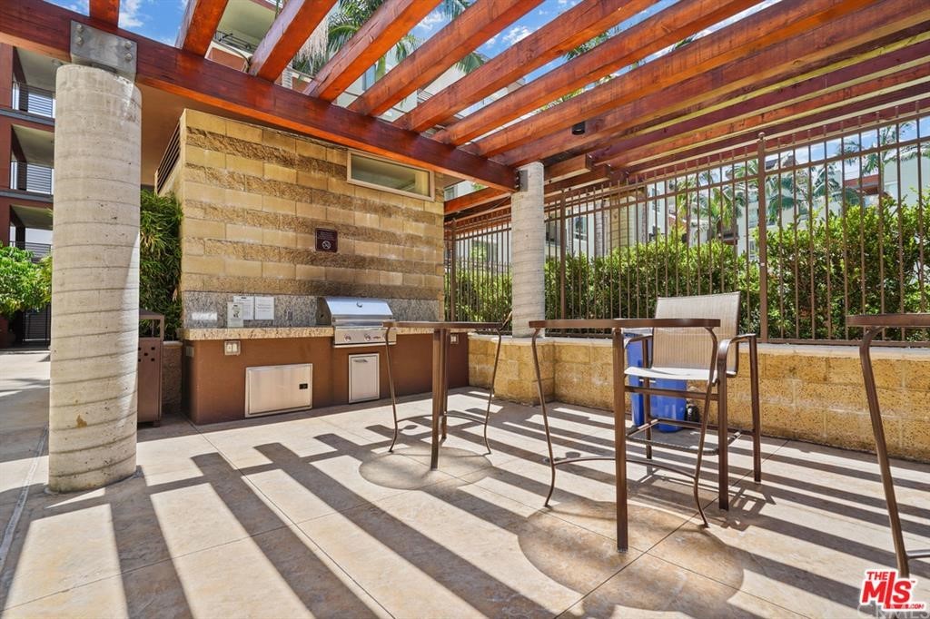 100 South Alameda Street, Unit 210 Los Angeles, CA 90012 - Photo 33 of 52 a living room with a large window and furniture