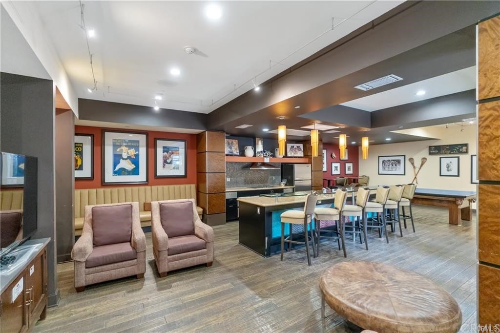 100 South Alameda Street, Unit 210 Los Angeles, CA 90012 - Photo 35 of 52 a living room with lots of furniture and a flat screen tv