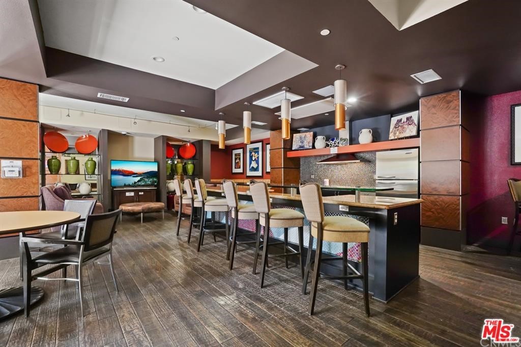 100 South Alameda Street, Unit 210 Los Angeles, CA 90012 - Photo 37 of 52 a view of a dining area with lots of wooden furniture and stainless steel appliances