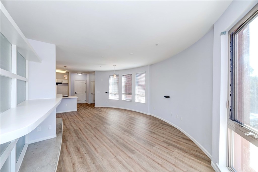 100 South Alameda Street, Unit 210 Los Angeles, CA 90012 - Photo 6 of 52 a view of empty room with wooden floor and fan