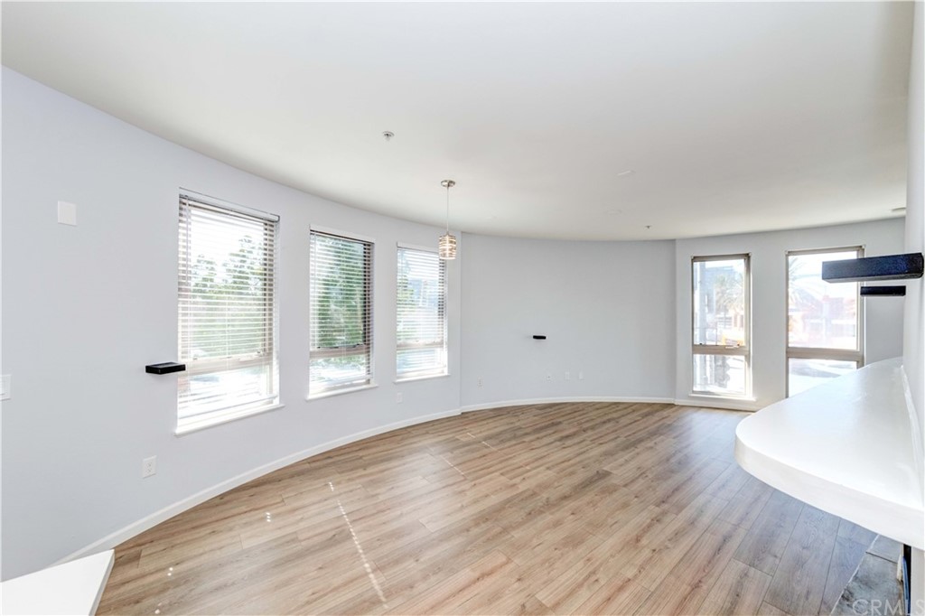 100 South Alameda Street, Unit 210 Los Angeles, CA 90012 - Photo 10 of 52 a view of an empty room with wooden floor and a window