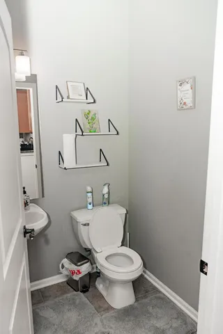 a white toilet sitting next to a bathroom sink