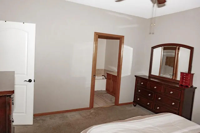 a bedroom with a bed and a dresser