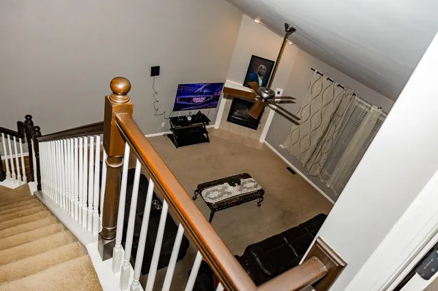 a view of a livingroom with furniture and stairs
