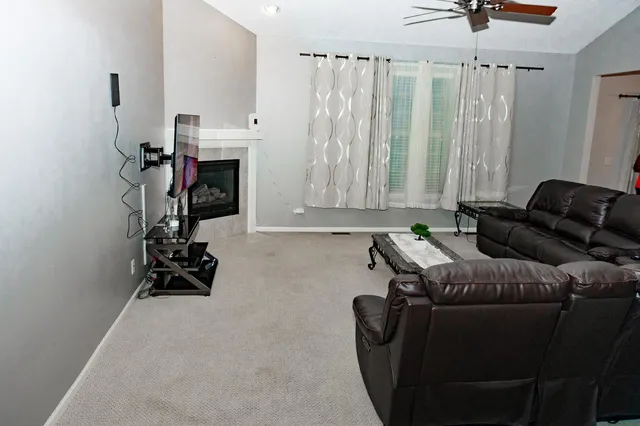 a living room with furniture a window and gym equipment