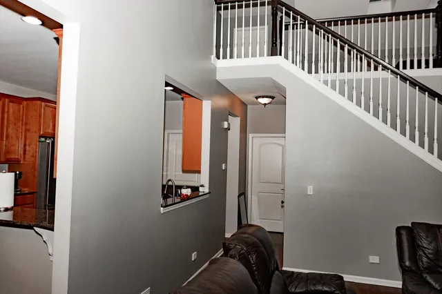 a view of staircase with white walls and a window