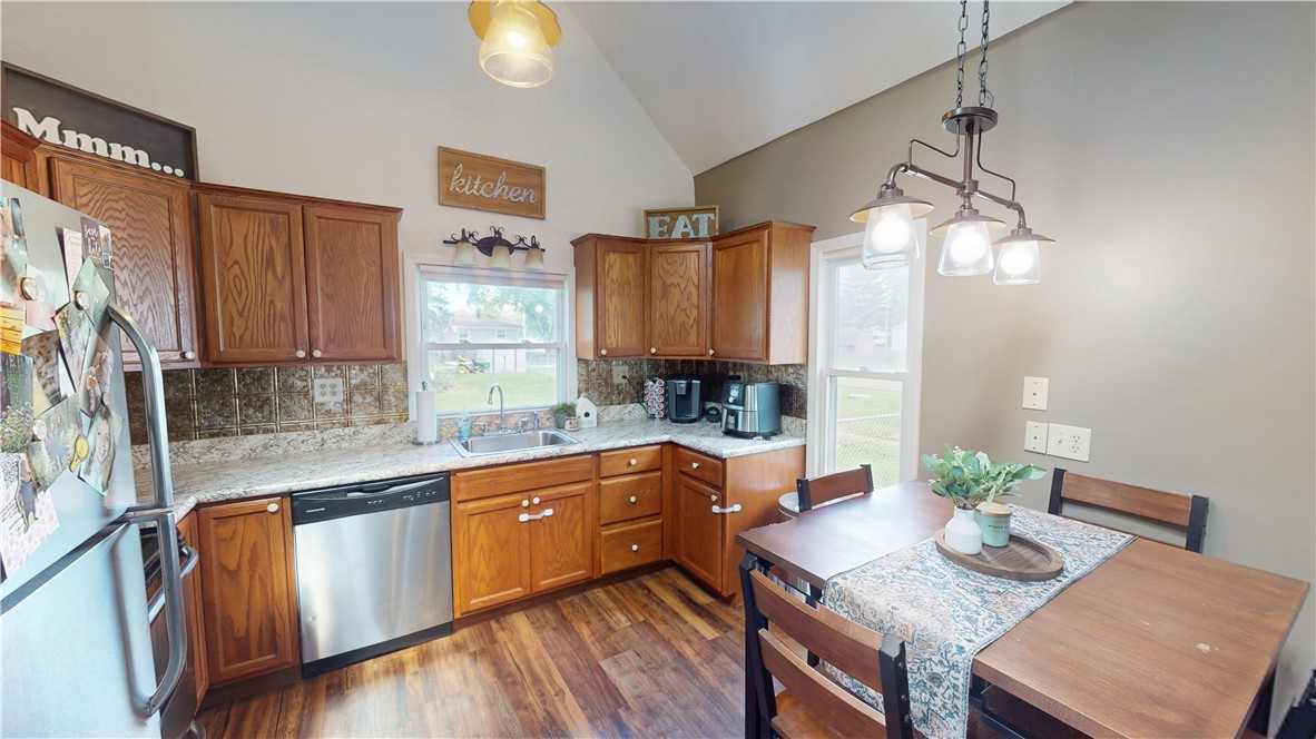 8 Chestnut Street Danville, IL 61832 - Photo 6 of 19 a open kitchen with granite countertop a sink dishwasher a stove and a refrigerator with wooden floor