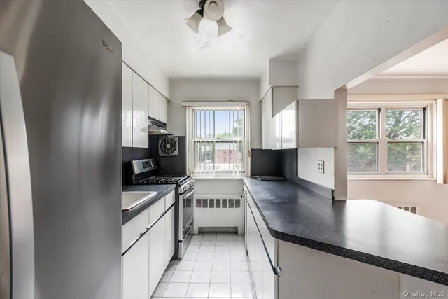 a kitchen with stainless steel appliances a stove sink and cabinets