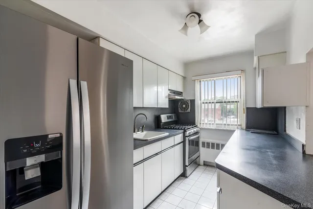 a kitchen with a refrigerator sink and stove