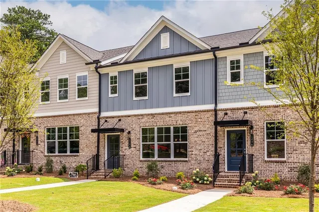 a front view of a house with yard and garage