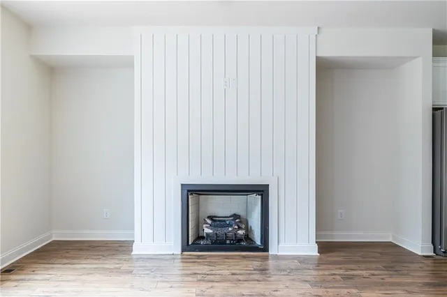 a living room with a fireplace and a hardwood floor
