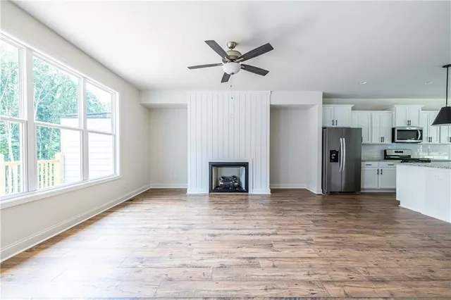a view of a kitchen with a sink and a ceiling fan