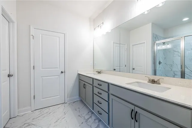 a bathroom with a shower and a glass door