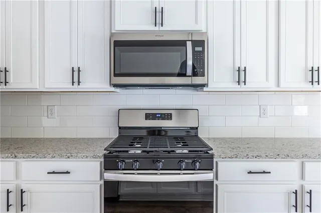 a stove top oven sitting inside of a kitchen