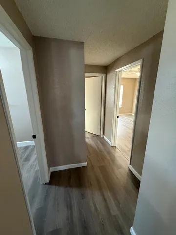 a large kitchen with cabinets wooden floor and stainless steel appliances