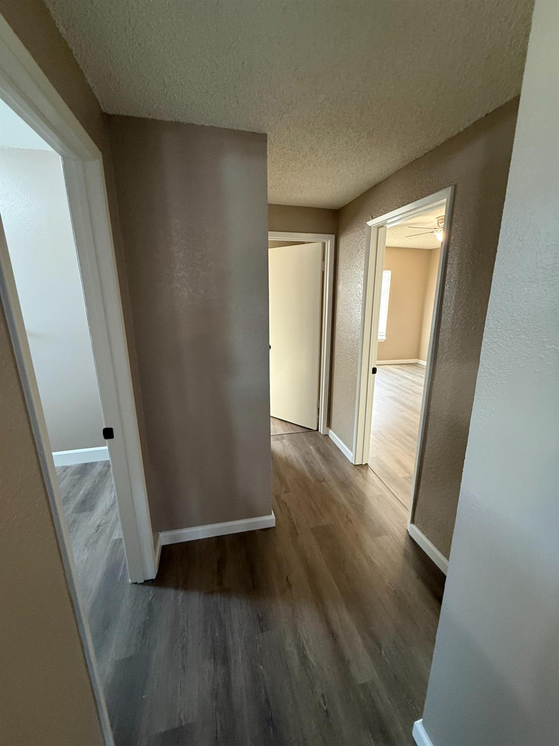 460 South Dearing Avenue Fresno, CA 93702 - Photo 14 of 23 an empty room with wooden floor and entrance