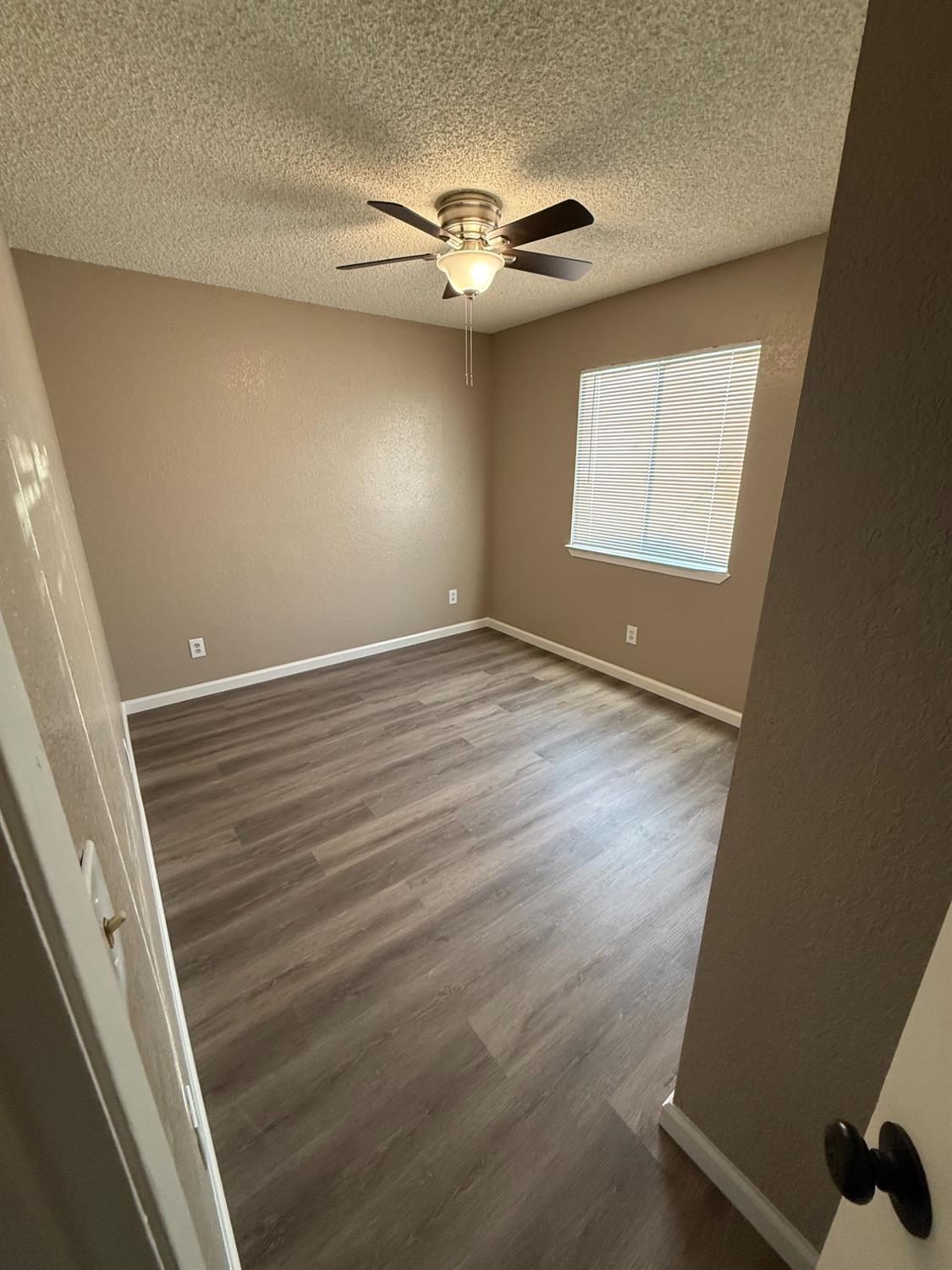 460 South Dearing Avenue Fresno, CA 93702 - Photo 20 of 23 a view of an empty room with wooden floor and a window
