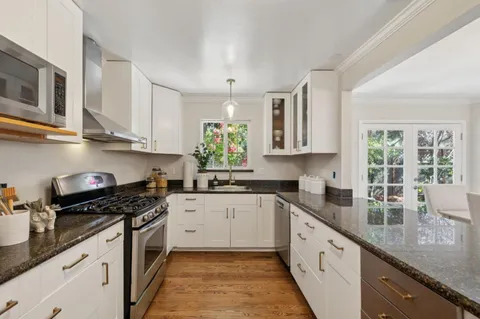 a kitchen with a sink a counter and cabinets