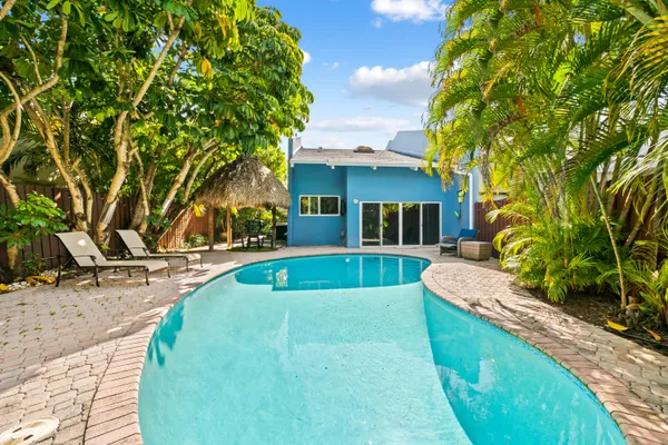 a view of house with swimming pool outdoor seating