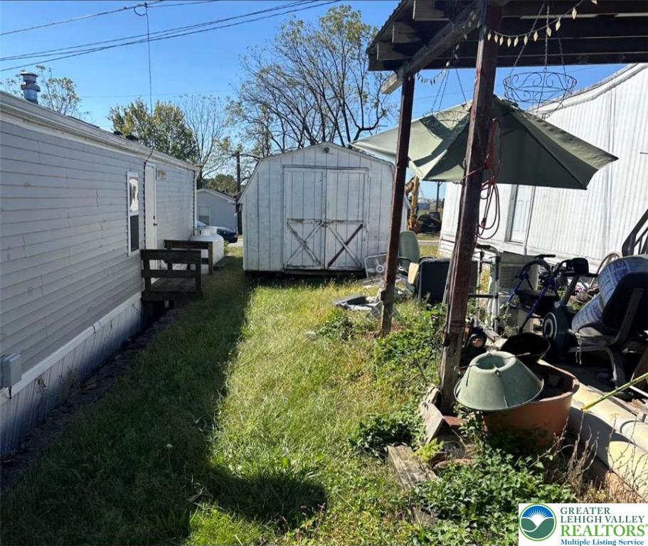 19 Roth Avenue Mertztown, PA 19539 - Photo 19 of 26 a backyard of a house with table and chairs under an umbrella