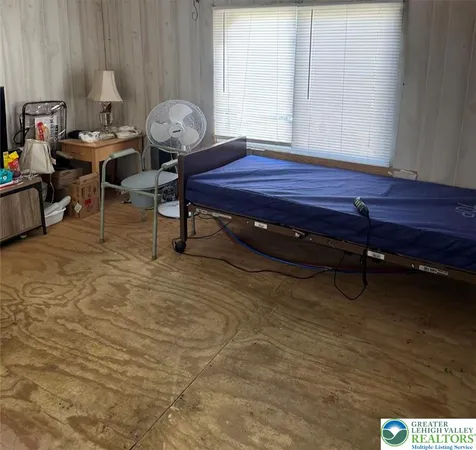 a living room with furniture a rug and a window