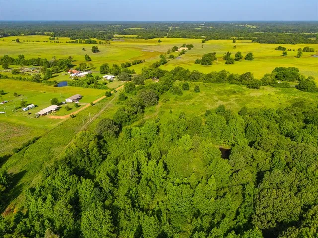 a view of a field with an ocean view