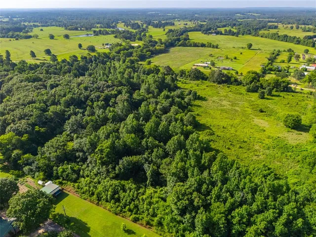 an aerial view of residential houses with outdoor space and swimming pool