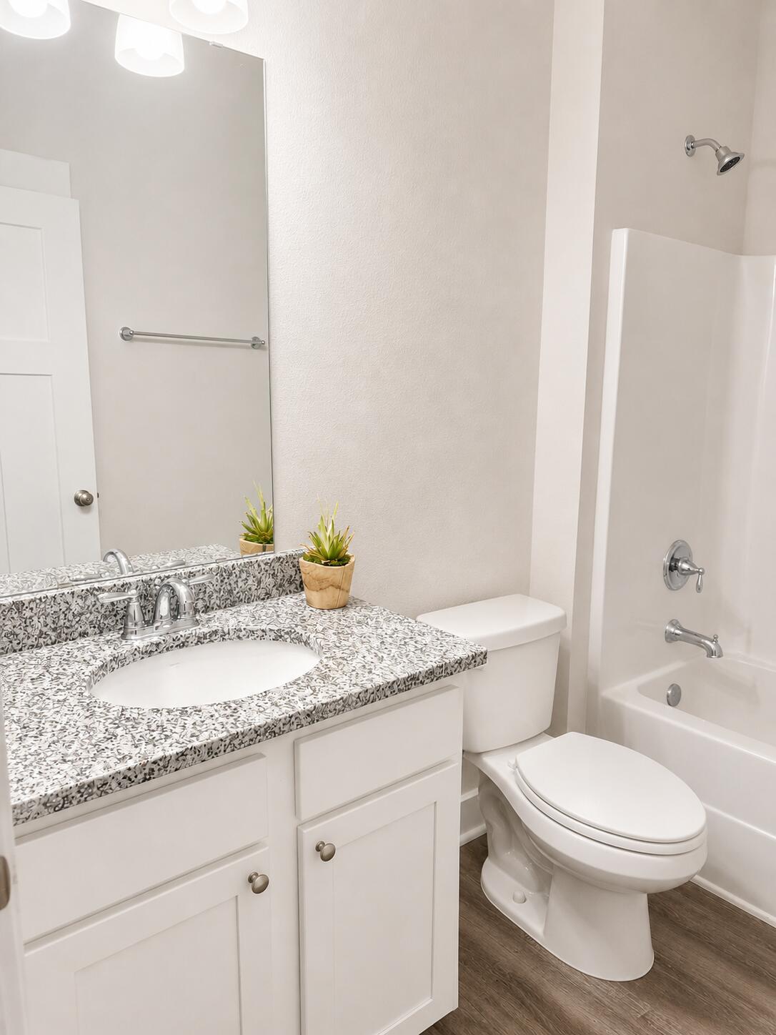 734 Quintana Street Crestview, FL 32539 - Photo 7 of 16 a bathroom with a granite countertop sink a toilet and a bathtub