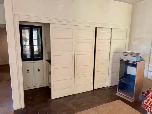 a bedroom with furniture and a window