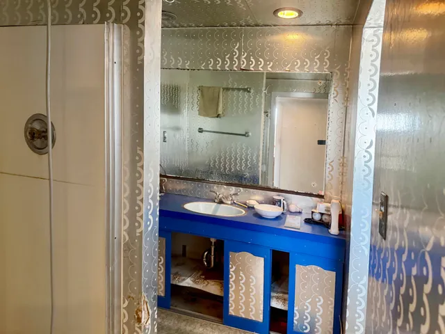 a bathroom with a sink a toilet and mirror