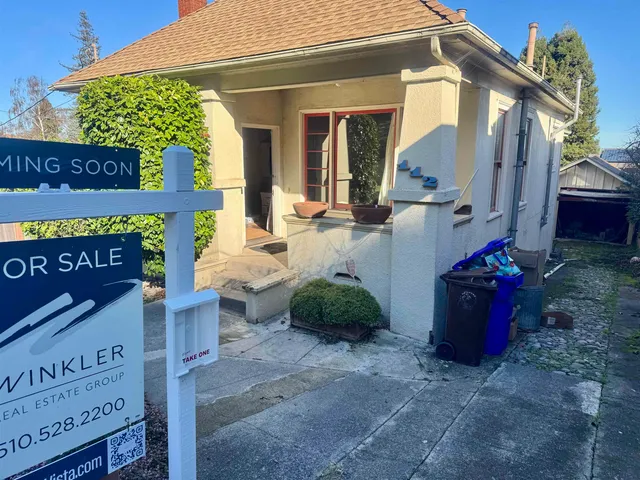 a view of a street with potted plants