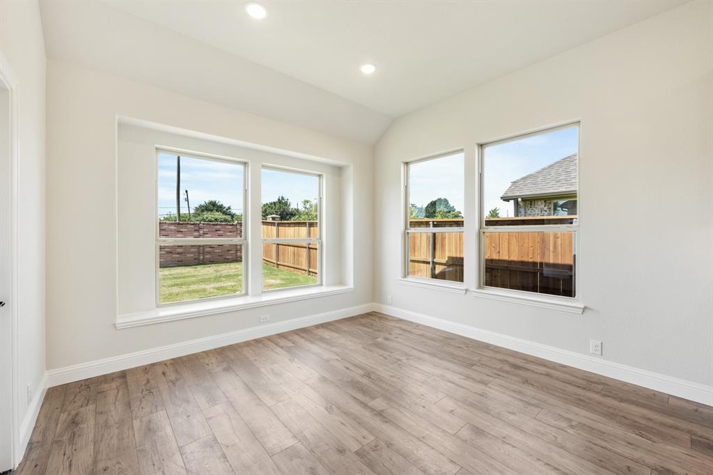 721 Seahawk Street Joshua, TX 76058 - Photo 15 of 40 an empty room with wooden floor and windows
