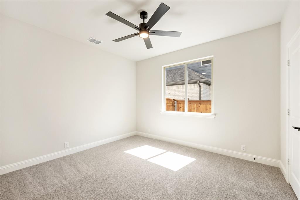 721 Seahawk Street Joshua, TX 76058 - Photo 24 of 40 an empty room with a window and a fan
