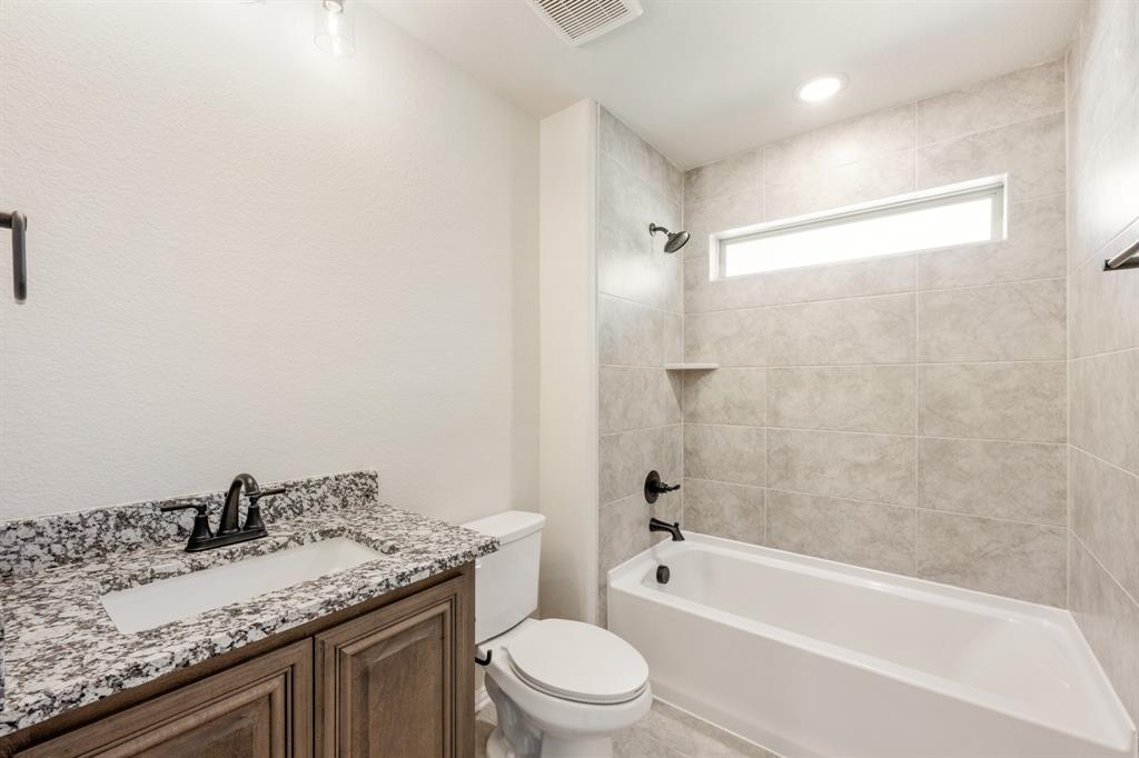 721 Seahawk Street Joshua, TX 76058 - Photo 36 of 40 a bathroom with a granite countertop sink a toilet and bathtub