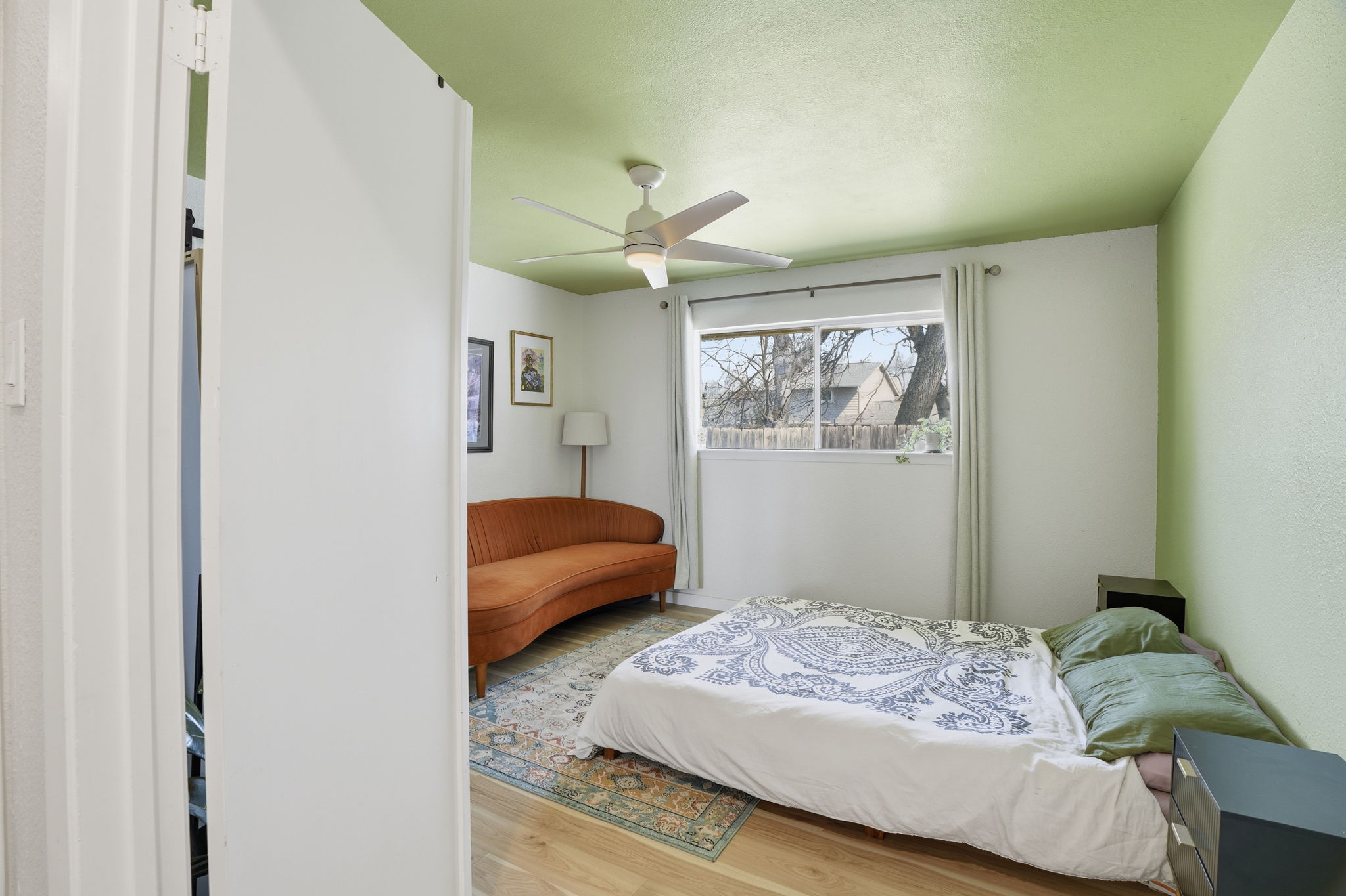 10305 Golden Quail Drive Austin, TX 78758 - Photo 21 of 39 a bedroom with a bed and a chandelier