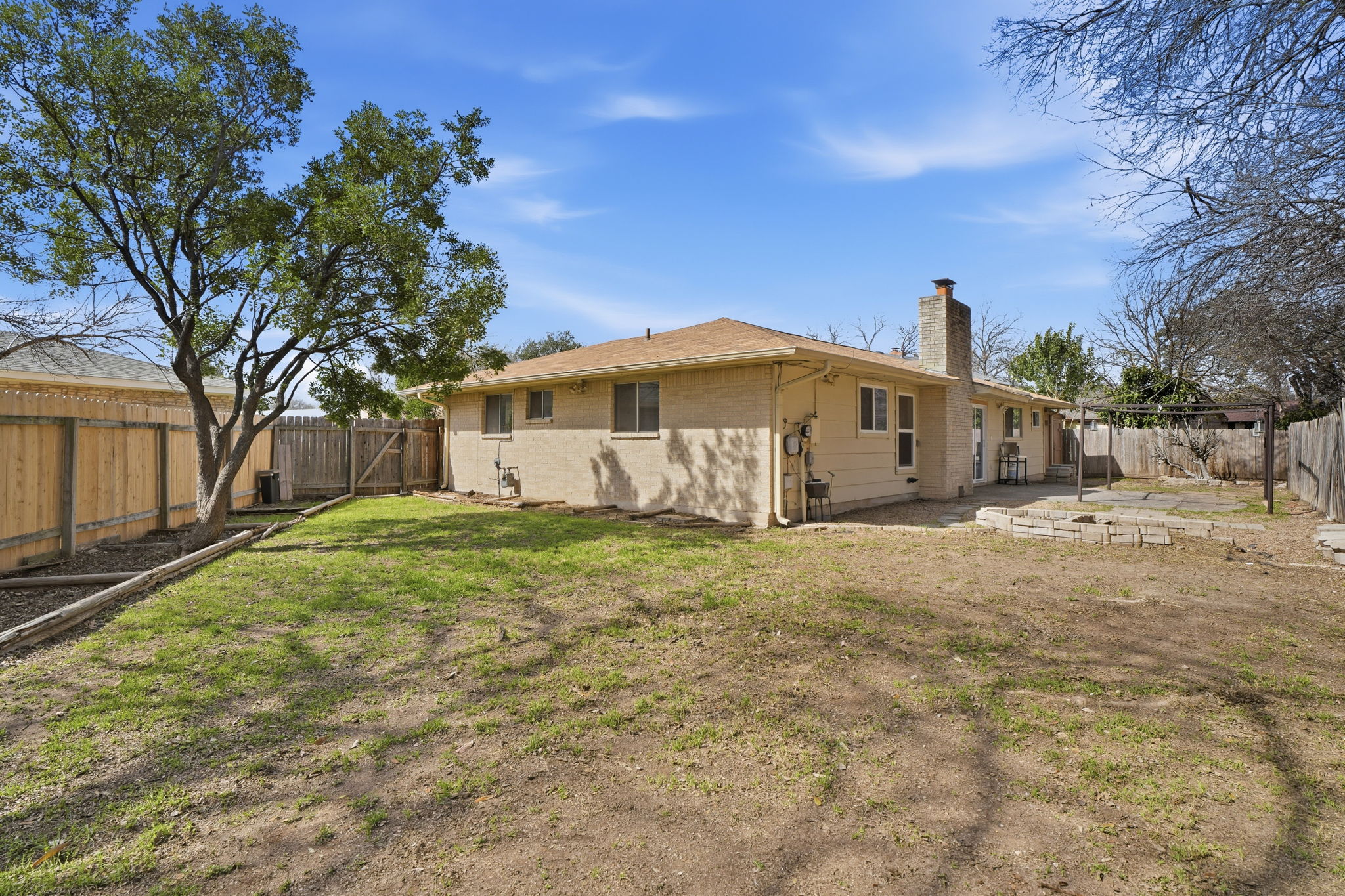 10305 Golden Quail Drive Austin, TX 78758 - Photo 35 of 39 a view of a large house with a large tree and a yard