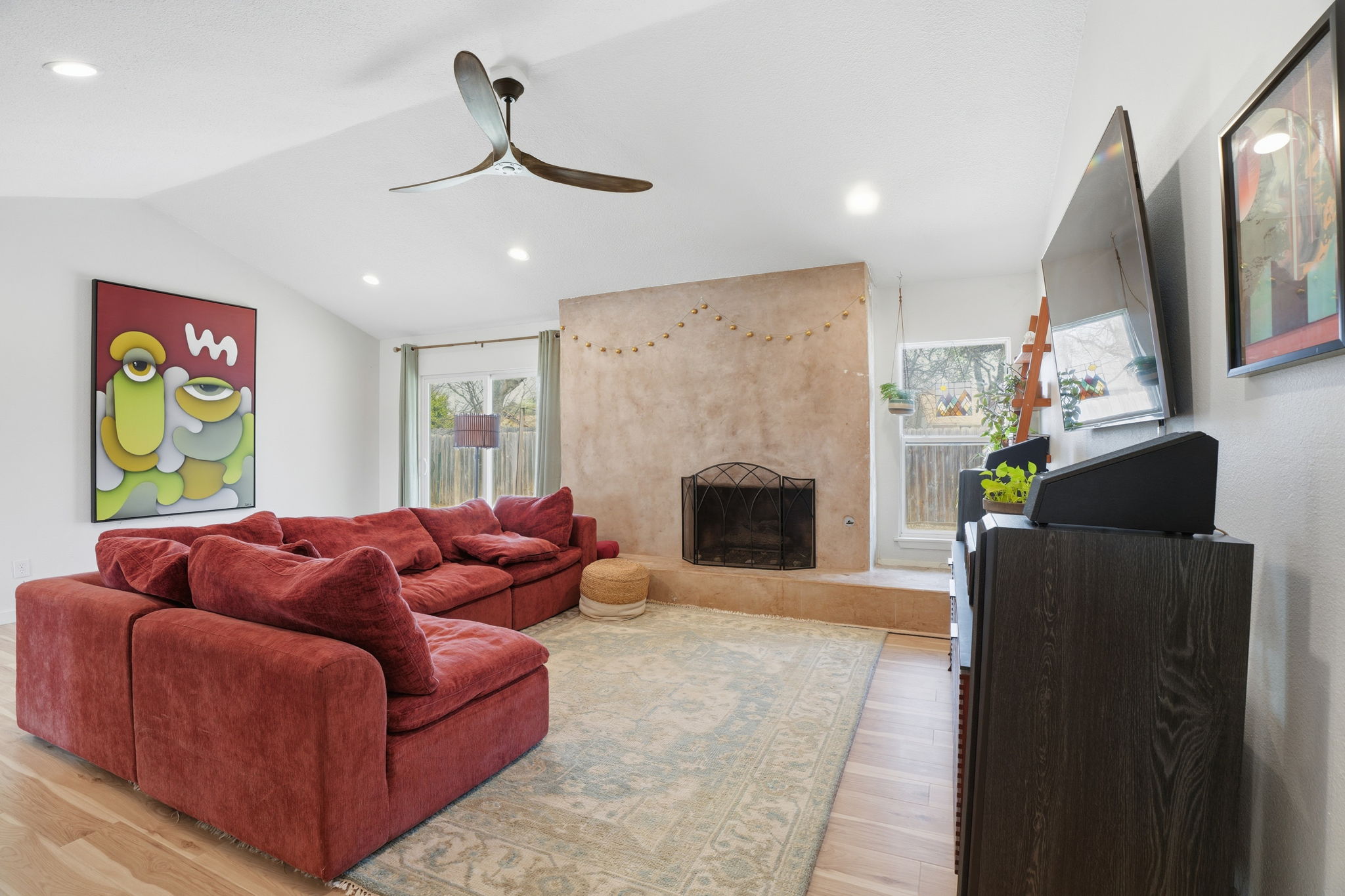 10305 Golden Quail Drive Austin, TX 78758 - Photo 7 of 39 a living room with furniture a fireplace and a chandelier