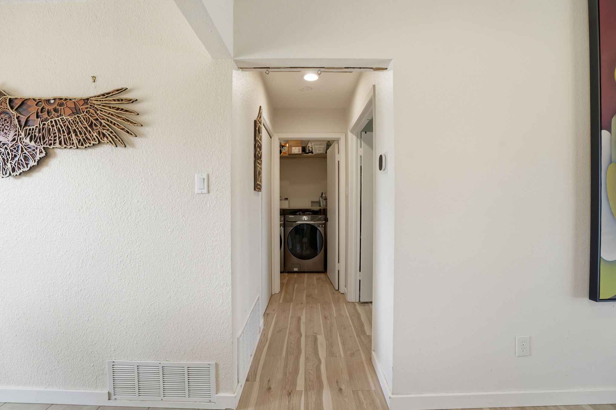 10305 Golden Quail Drive Austin, TX 78758 - Photo 9 of 39 a view of a hallway with wooden floor and a bathroom