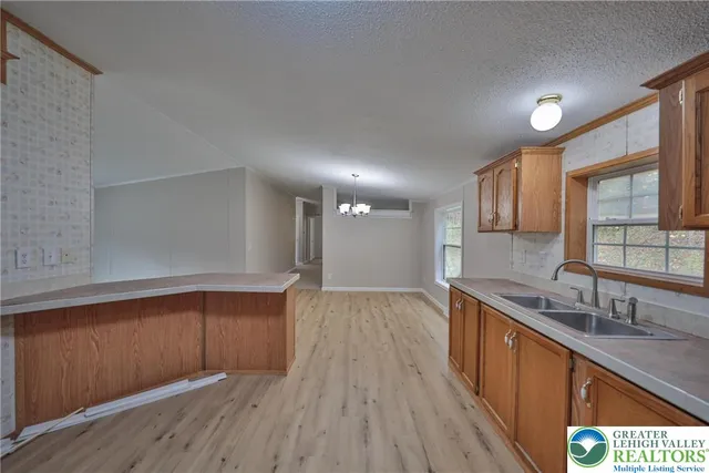 a kitchen with wooden floors and wooden cabinets