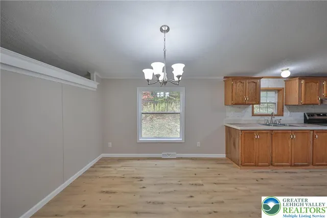 a view of a kitchen with marble kitchen and wooden floor